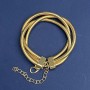 Triple bracelet in gold-tone metal with an extension chain